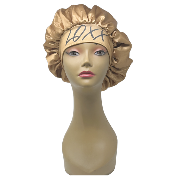 Gold satin bonnet with elastic band displayed on a mannequin head, ideal for protecting hair while sleeping.