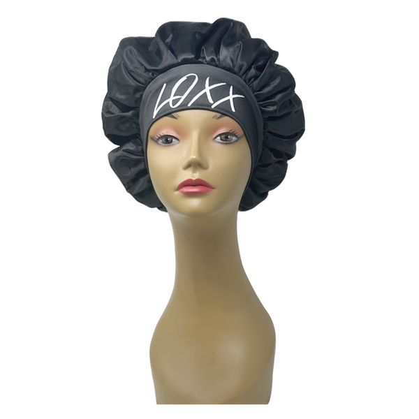 Black satin bonnet with elastic band displayed on a mannequin, suitable for protecting hair during sleep.