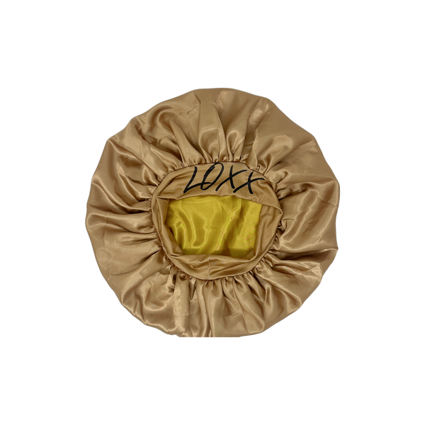Luxurious satin bonnet in beige with elastic band, ideal for protecting hair while sleeping.