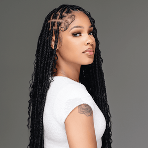 Model showcasing human hair boho braids in a stylish pose, featuring long, sleek black braids.