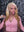Influencer wearing Itty X Romanjay Fall Color Wig, styled in a pink outfit against a geometric background.
