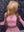Influencer Itty showcasing the Itty X Romanjay Fall Color Wig, styled in a pink outfit against a geometric backdrop.