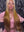 Influencer Itty showcasing the Itty X Romanjay fall gradient wig with stylish long hair against a textured background.