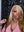 Influencer Itty showcasing the Itty X Romanjay Fall Color Wig, featuring stunning golden blonde waves and a chic style.