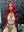 Influencer Itty showcasing the Itty X Romanjay Fall Color Wig in vibrant red, perfect for fall styling.