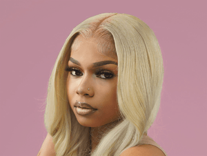 Stunning model showcasing blonde bundles hairstyle with sleek, straight strands against a pink background.