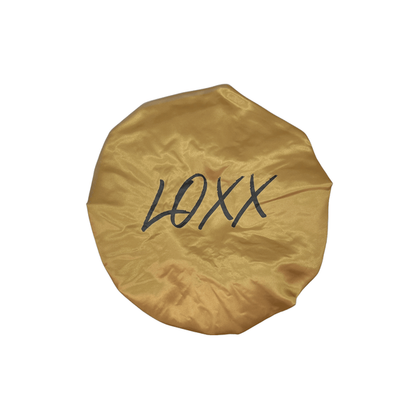 Gold satin bonnet with elastic band, decorated with the word 'LOXXX' in black, perfect for women's hair care.
